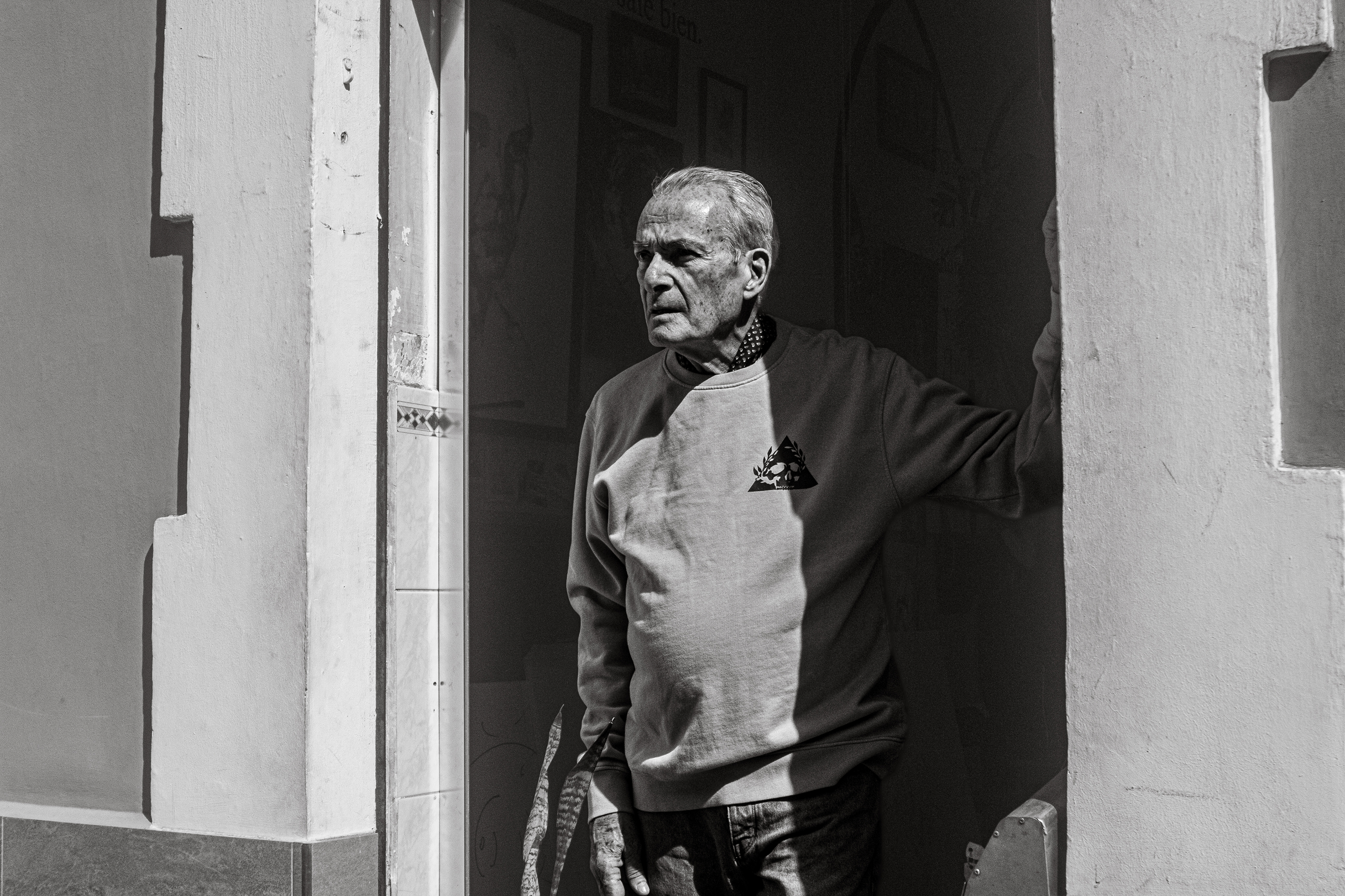 Man standing in a doorway wearing Canary Famous shirt